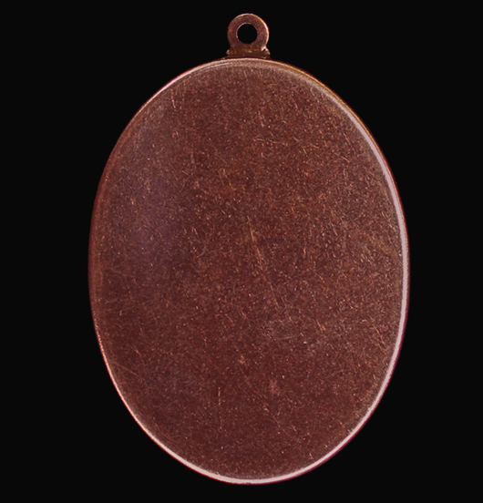 black medallion in porcelain with written 